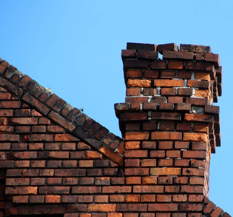 Damaged chimney on an Dolton home showing cracks and missing mortar